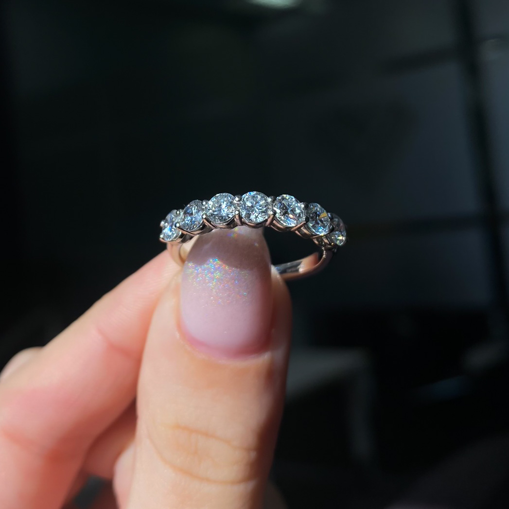 Star Lot : A sparkling example of a seven stone bright Diamond half eternity  ring, of .33 carats of