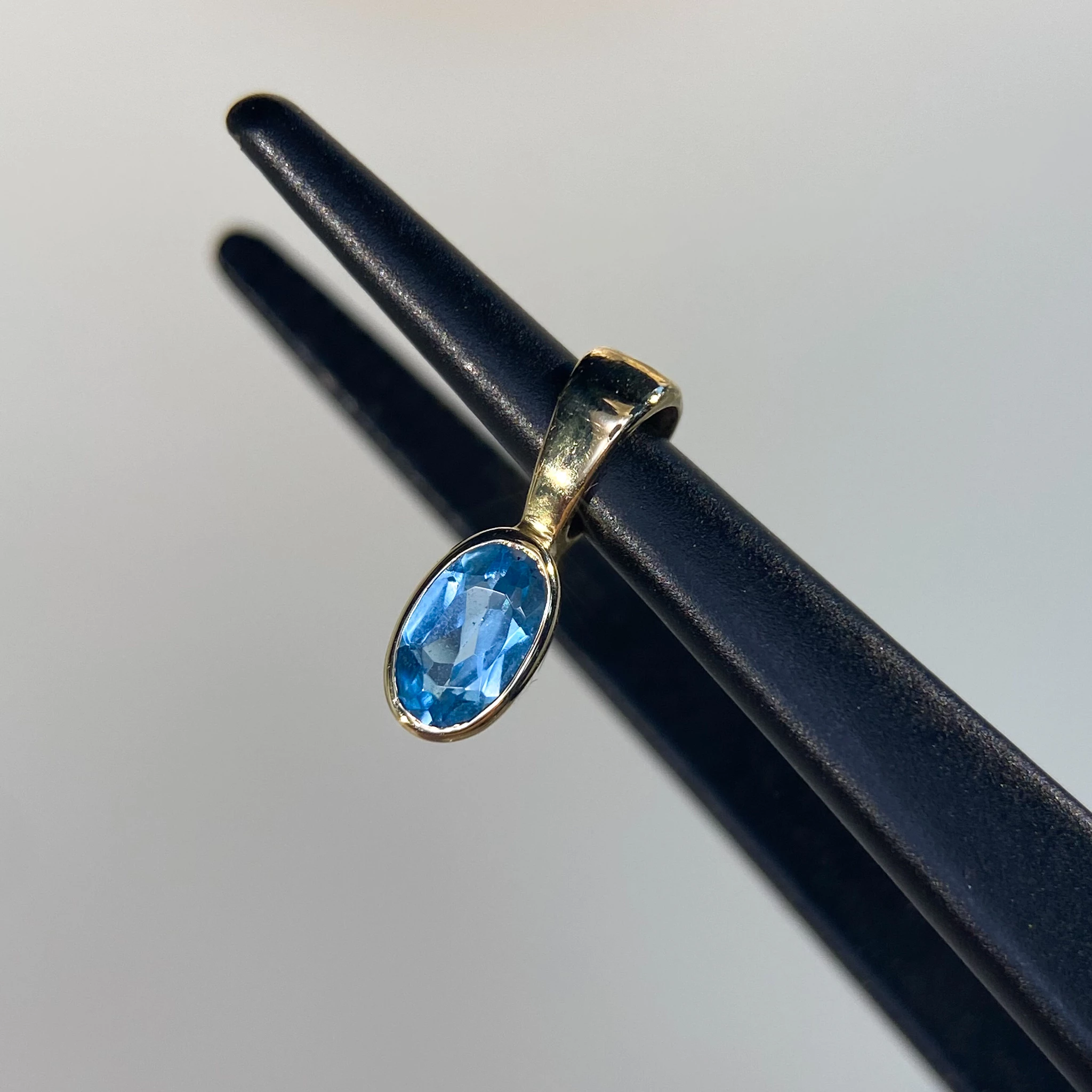 Oval Swiss Blue Topaz Rubover Pendant in 9K Yellow Gold